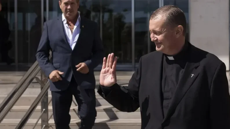 El sacerdote de Barcelona Custodio Ballester, saluda a las personas que se acercaron al Palacio de la Justicia de Málaga para darles su apoyo el 1 de octubre de 2025. (EFE/Carlos Díaz)
